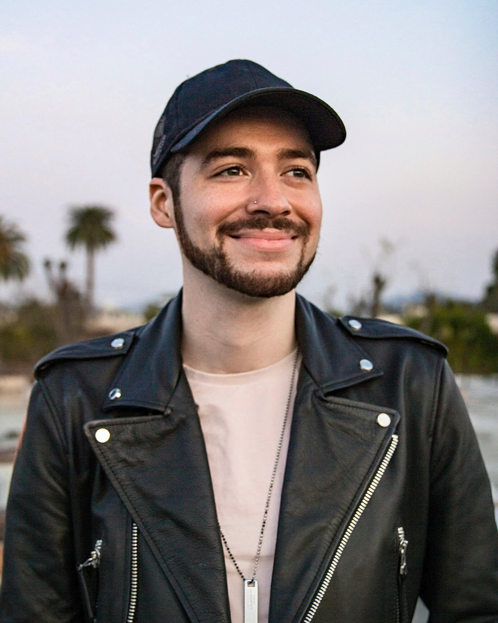 Tadjh smiling in a leather jacket